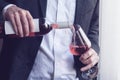 Man pouring rose wine into a glass