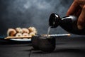 Man pouring sake into sipping bowl Royalty Free Stock Photo