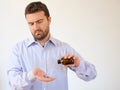 Man pouring some pills from a bottle