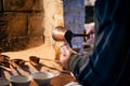 Man pouring Turkish coffee from a traditional brass pot