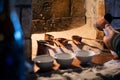 Man pouring Turkish coffee from a traditional brass pot