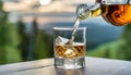 Man pouring whiskey into a glass outdoors Royalty Free Stock Photo