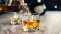 Man pouring whiskey into glasses, drinking alcoholic beverage