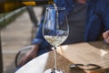 Man pouring wine into glass in a restaurant. Waiter serving drink. Wine tasting concepts