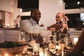 Man pouring wine for his wife at a dinner party Royalty Free Stock Photo