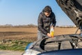 Man pours into the car yellow liquid for the wiper Royalty Free Stock Photo