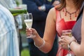 Man pours champagne in wineglasses of a woman dressed in red Royalty Free Stock Photo