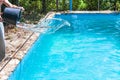 Man pours of disinfectant from bucket in pool Royalty Free Stock Photo