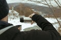 A man pours a drink from a thermos into the lid outdoor Royalty Free Stock Photo