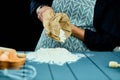 Man pours flour from a bag to table. Male hands holding a cracked egg. Breaking an egg. Man is baking, cooking.