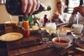 A man pours a glass of champagne. Close up of flowing sparkling wine Royalty Free Stock Photo