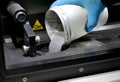 Man pours metal powder into the chamber of a laser sintering machine Royalty Free Stock Photo