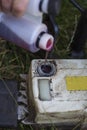 Man pours red engine oil into the mechanism