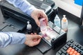 Man pours red ink into the photo printer Royalty Free Stock Photo