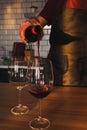 A man pours red wine into a glass Royalty Free Stock Photo