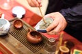 Man pours tealeafs by bamboo Tea Scoop Royalty Free Stock Photo