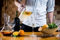 Man pours white homemade sangria