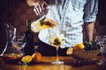 Man pours white homemade sangria