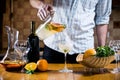 Man pours white homemade sangria