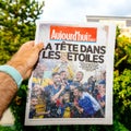 Man POV reading park newspaper announcing France champion title Royalty Free Stock Photo