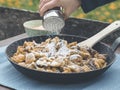 Man powdering kaiserschmarrn with sugar on alp