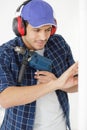 man with power drill wearing ear defenders Royalty Free Stock Photo