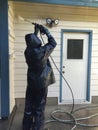 Man power washing a home.