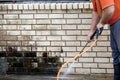 Man powerwashing mold of wall - DIY Royalty Free Stock Photo