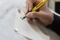 hand practices decorating letters from a Torah scroll written on parchment in Hebrew Royalty Free Stock Photo