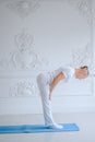 Man practicing advanced yoga against a white background Royalty Free Stock Photo