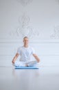 Man practicing advanced yoga against a white background Royalty Free Stock Photo
