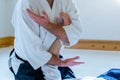 Man practicing aikido in a dojo background. Royalty Free Stock Photo