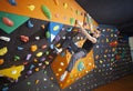 Man practicing bouldering in indoor climbing gym