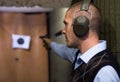 Man practicing handgun shooting at target at pistol range Royalty Free Stock Photo