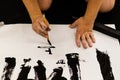 A man practicing Japanese calligraphy