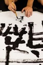 A man practicing Japanese calligraphy