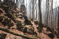 Man practicing kendo with shinai bamboo sword on rocks and forest background. Place for text or advertising