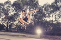 Man practicing radical skate board jumping and enjoying tricks and stunts in concrete half pipe skating track in sport and healthy Royalty Free Stock Photo