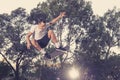 Man practicing radical skate board jumping and enjoying tricks and stunts in concrete half pipe skating track in sport and healthy Royalty Free Stock Photo