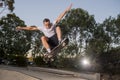 Man practicing radical skate board jumping and enjoying tricks and stunts in concrete half pipe skating track in sport and healthy Royalty Free Stock Photo