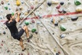 Man practicing rock climbing on artificial wall indoors. Active Royalty Free Stock Photo