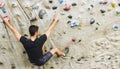 Man practicing rock climbing on artificial wall indoors. Active Royalty Free Stock Photo