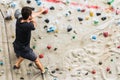 Man practicing rock climbing on artificial wall indoors. Active lifestyle and bouldering concept Royalty Free Stock Photo