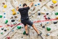 Man practicing rock climbing on artificial wall indoors. Active lifestyle and bouldering concept Royalty Free Stock Photo