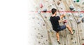 Man practicing rock climbing on artificial wall indoors. Active lifestyle and bouldering concept with copy space Royalty Free Stock Photo