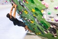 Man practicing rock climbing on artificial wall indoors. Active lifestyle and bouldering concept Royalty Free Stock Photo