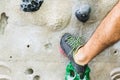 Man practicing rock climbing on artificial wall indoors. Active lifestyle and bouldering concept Royalty Free Stock Photo