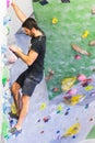 Man practicing rock climbing on artificial wall indoors. Active lifestyle and bouldering concept Royalty Free Stock Photo