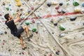 Man practicing rock climbing on artificial wall indoors. Active Royalty Free Stock Photo