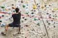 Man practicing rock climbing on artificial wall indoors. Active Royalty Free Stock Photo